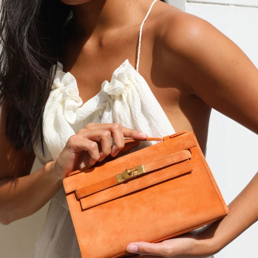 Hermes Mini Kelly Pochette Bag in Orange Veau Doblis Leather with Gold Hardware | Studio Nafay